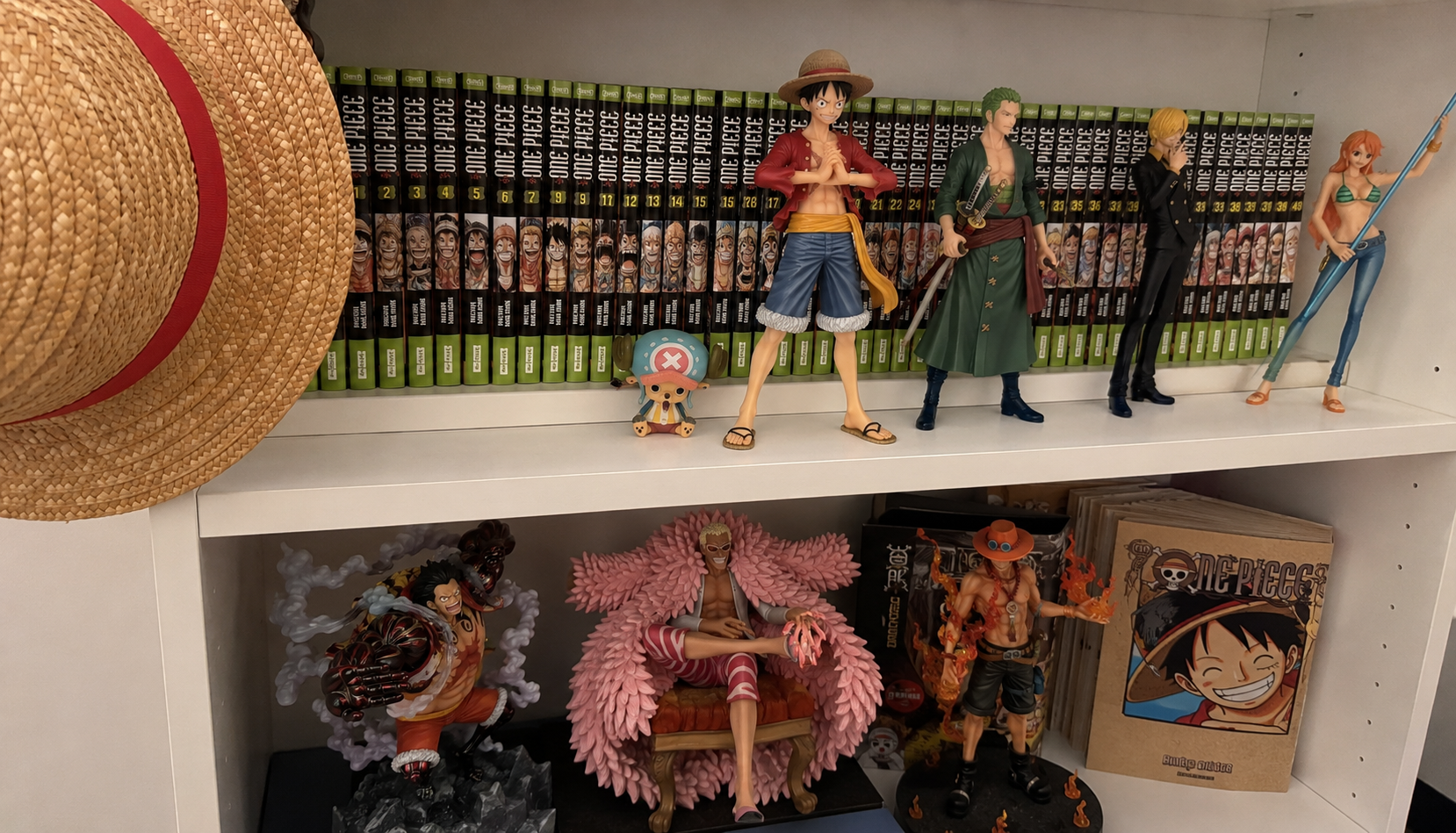 Colección de figuras y volúmenes de One Piece con Luffy, Zoro, Sanji, Nami y Ace
